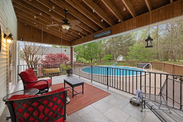 view of patio / terrace featuring ceiling fan and a fenced in pool