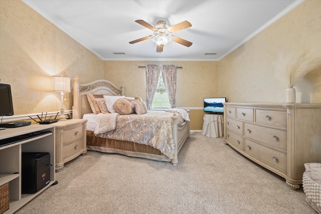 carpeted bedroom with ornamental molding and ceiling fan