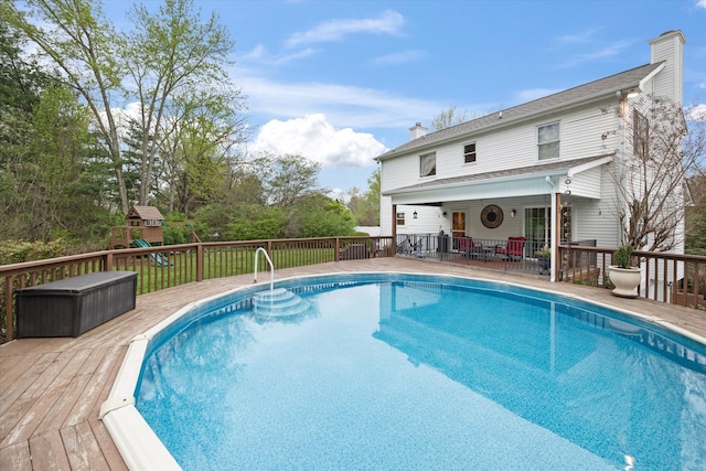 view of swimming pool with a wooden deck