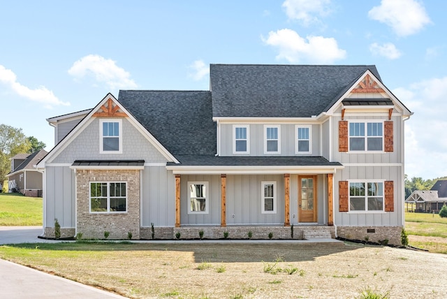 view of front of house with crawl space, board and batten siding, a standing seam roof, and roof with shingles