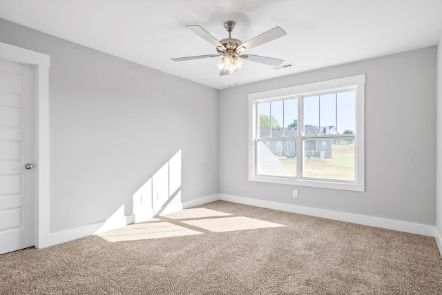 empty room with visible vents, baseboards, and light colored carpet