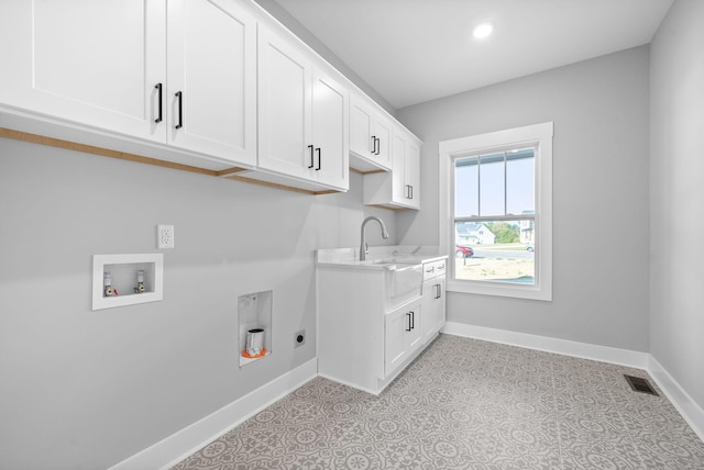 laundry room featuring washer hookup, visible vents, cabinet space, and baseboards