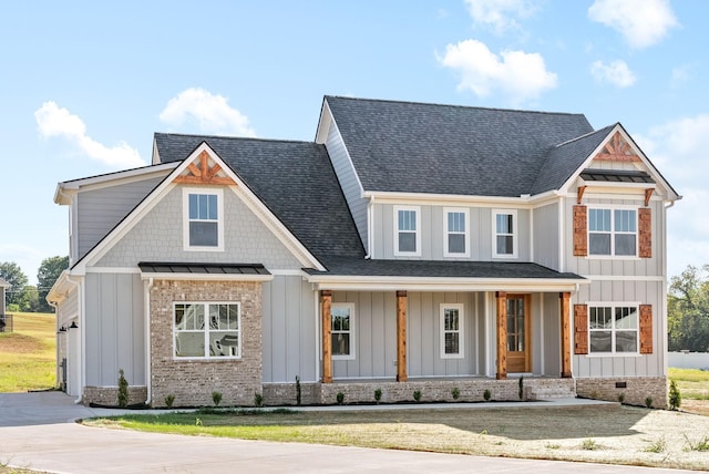 view of front of property with a standing seam roof, concrete driveway, board and batten siding, and roof with shingles