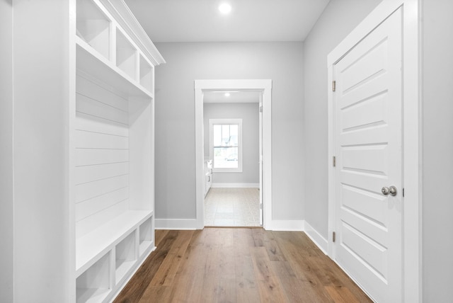 mudroom with wood finished floors and baseboards