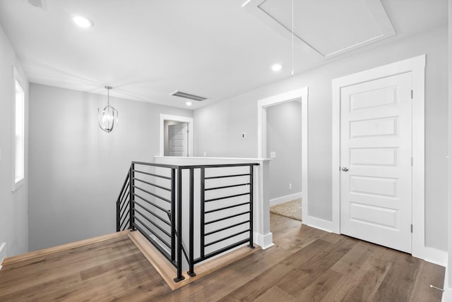 interior space featuring visible vents, baseboards, attic access, recessed lighting, and wood finished floors