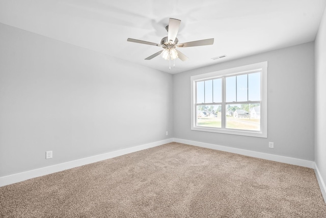 spare room featuring visible vents, baseboards, carpet, and ceiling fan