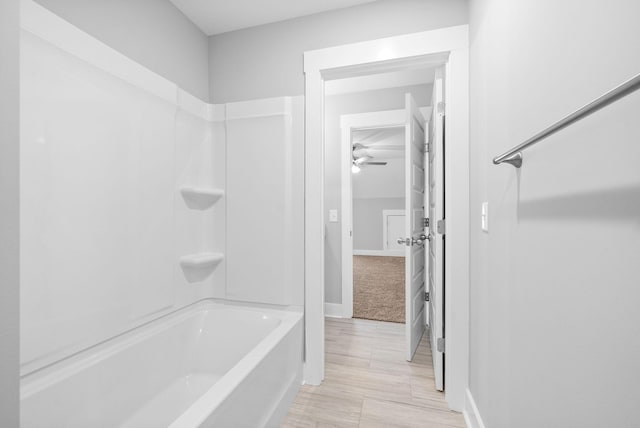 full bath with baseboards and shower / tub combination