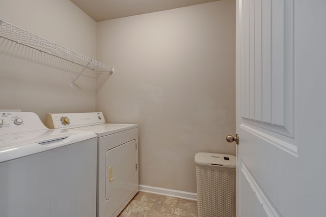 washroom with washing machine and clothes dryer