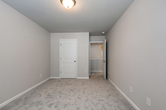 unfurnished bedroom with light colored carpet