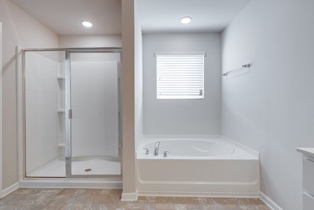 bathroom featuring vanity and plus walk in shower