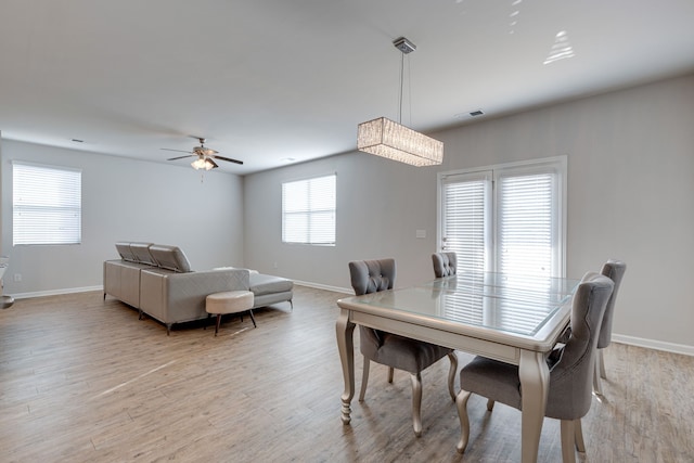 dining room with light hardwood / wood-style floors and ceiling fan