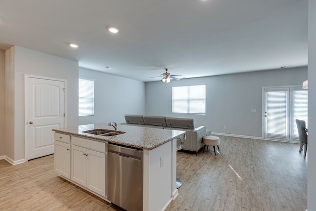 kitchen with an island with sink, white cabinets, dishwasher, ceiling fan, and sink