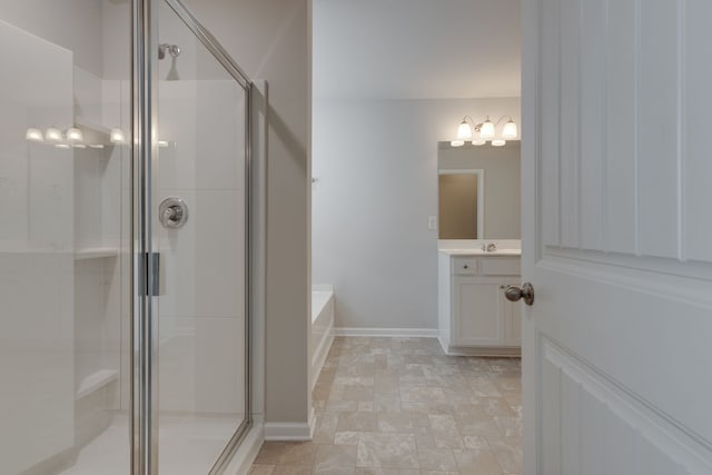 bathroom featuring independent shower and bath and vanity