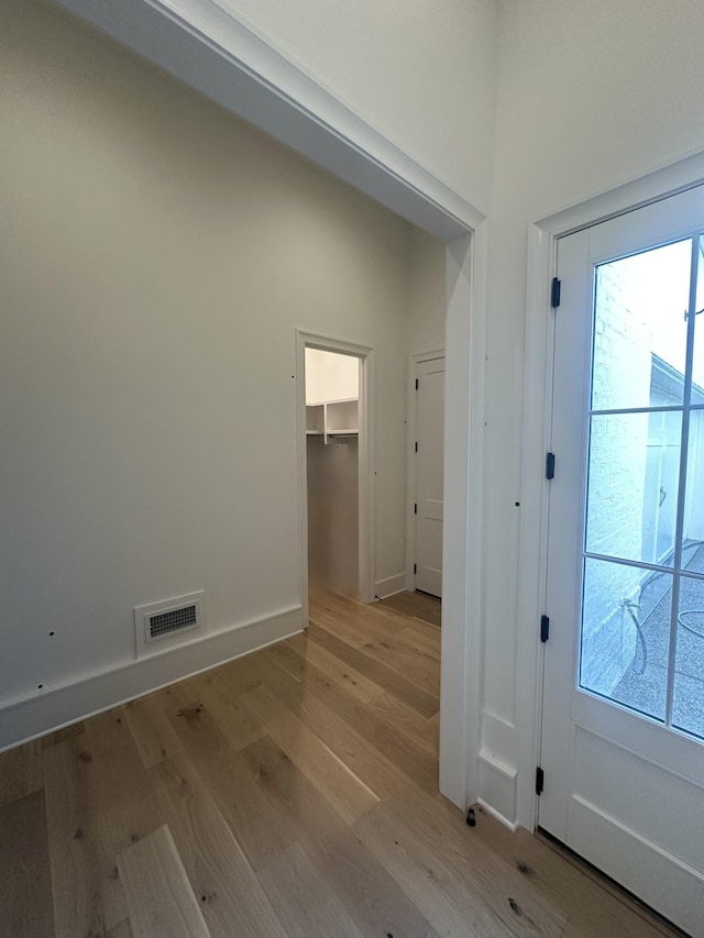 entryway featuring a high ceiling and light wood-type flooring