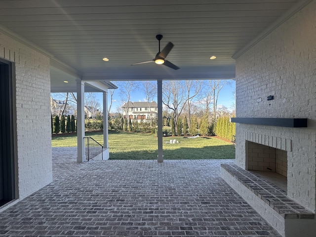 view of patio / terrace featuring an outdoor brick fireplace and ceiling fan