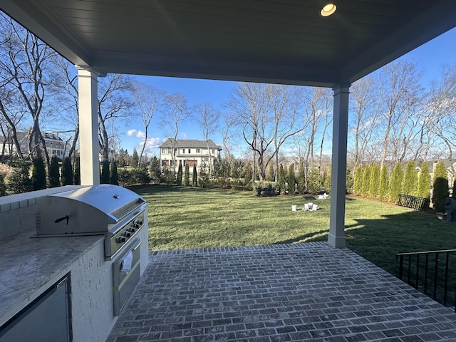 view of patio with grilling area and an outdoor kitchen