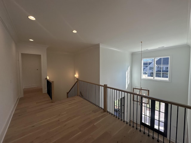 hallway with crown molding and hardwood / wood-style flooring