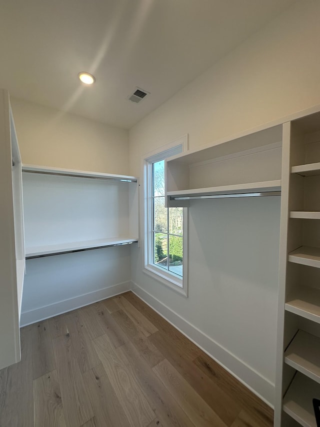 walk in closet featuring light hardwood / wood-style flooring