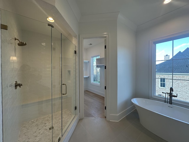 bathroom with shower with separate bathtub and tile patterned floors