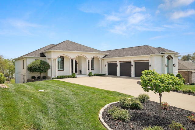 mediterranean / spanish home featuring a garage and a front yard