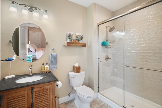 bathroom with walk in shower, vanity, tile floors, and toilet