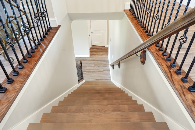 staircase with light hardwood / wood-style floors