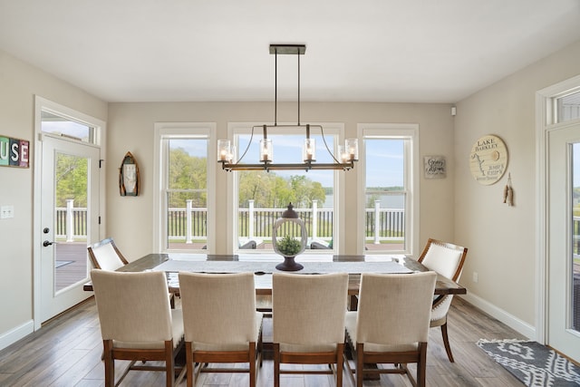 dining area featuring hardwood / wood-style floors and a chandelier