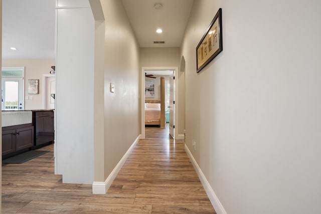 hallway with hardwood / wood-style floors