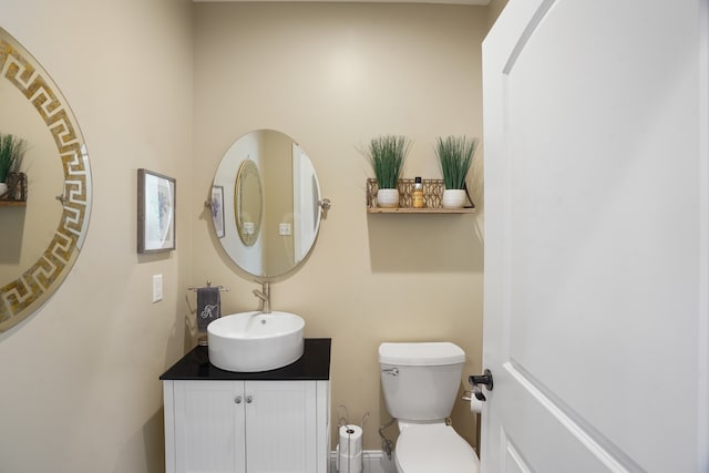 bathroom featuring toilet and vanity