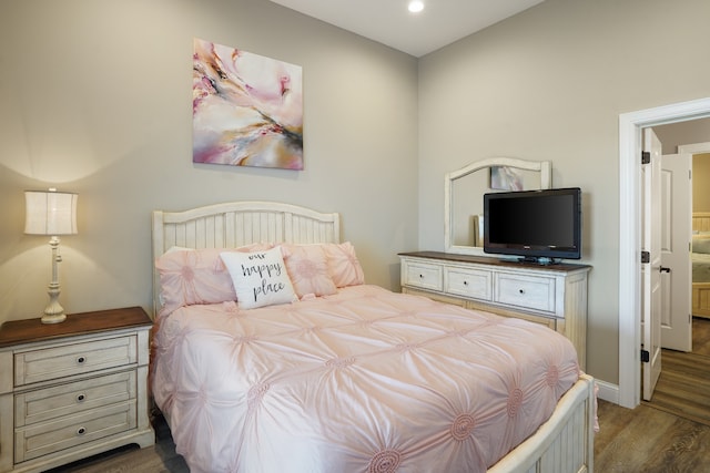 bedroom featuring connected bathroom and dark hardwood / wood-style floors