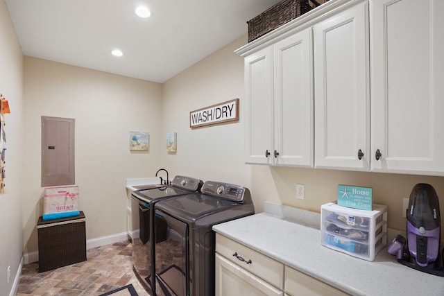 washroom with sink, cabinets, and washing machine and clothes dryer