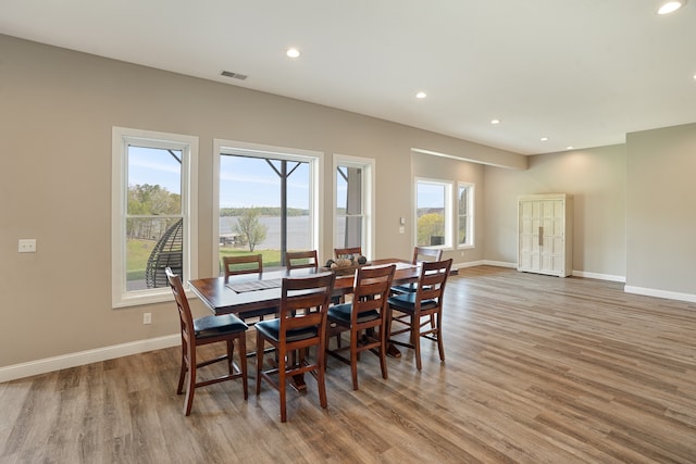 dining area with light hardwood / wood-style floors and a wealth of natural light