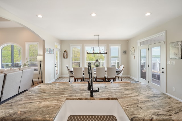 dining room featuring a chandelier, plenty of natural light, and light hardwood / wood-style flooring