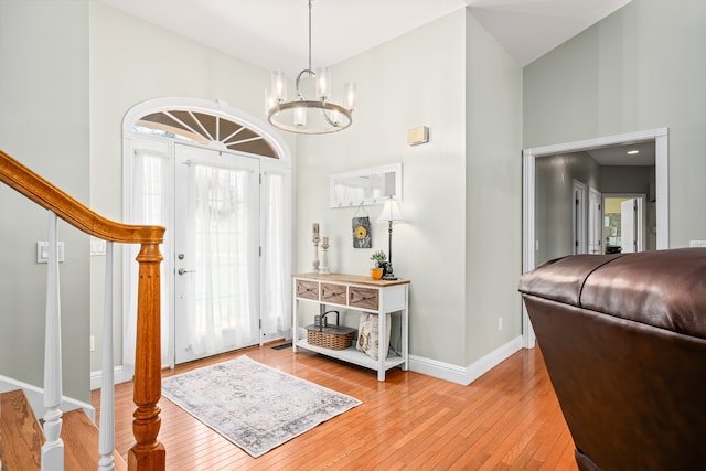 entrance foyer featuring high vaulted ceiling and light hardwood / wood-style flooring