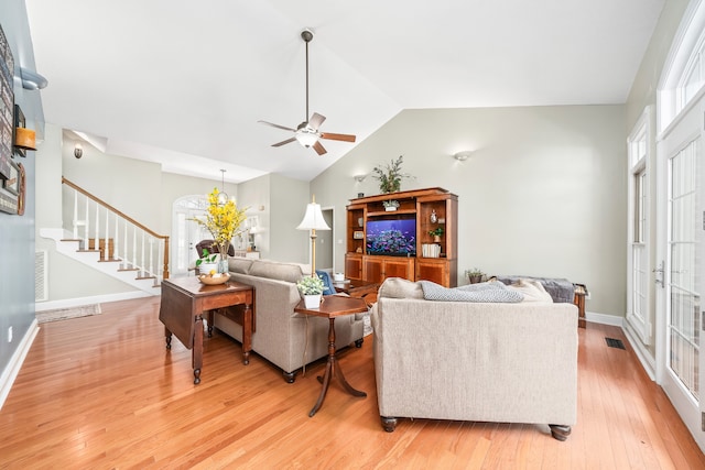 living room featuring high vaulted ceiling, light hardwood / wood-style floors, and ceiling fan