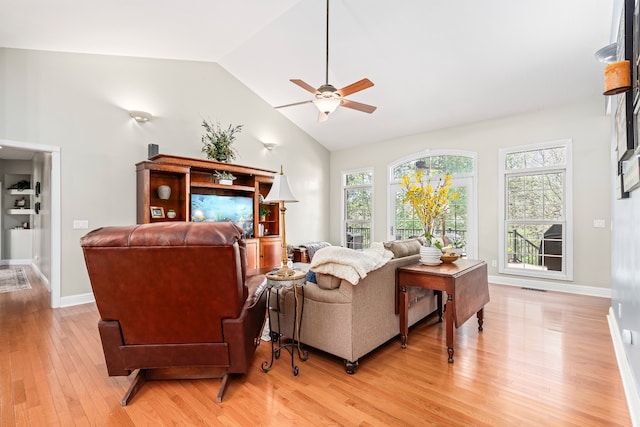 living room with a healthy amount of sunlight, light hardwood / wood-style floors, and ceiling fan