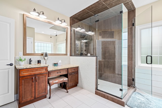 bathroom with walk in shower, tile floors, vanity, tile walls, and backsplash