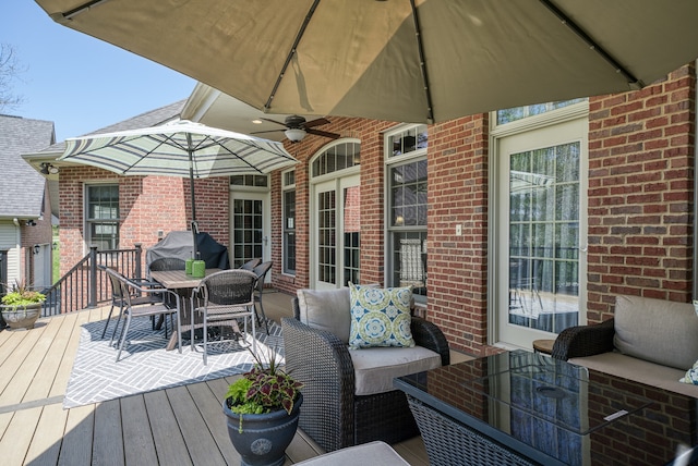 wooden deck featuring ceiling fan and outdoor lounge area