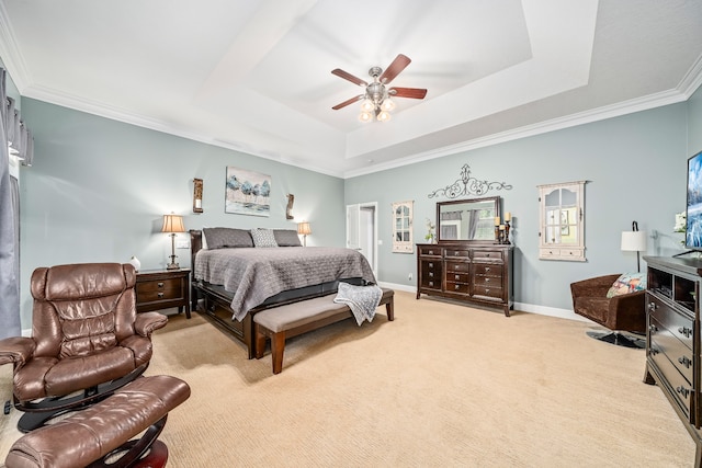 carpeted bedroom with crown molding, ceiling fan, and a tray ceiling