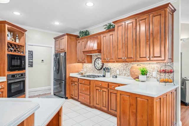 kitchen with premium range hood, tasteful backsplash, light tile flooring, and black appliances