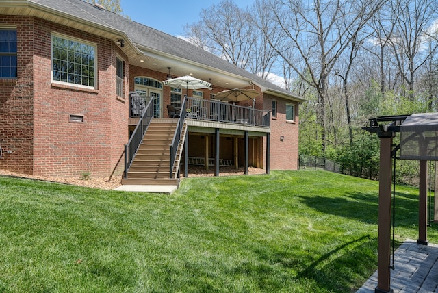 rear view of house featuring a deck and a yard