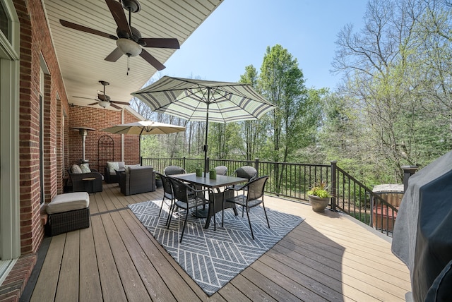 wooden terrace with ceiling fan and outdoor lounge area