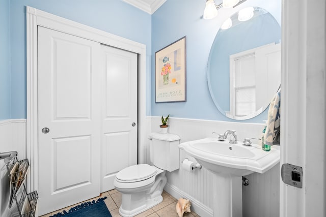 bathroom with tile floors, toilet, and crown molding