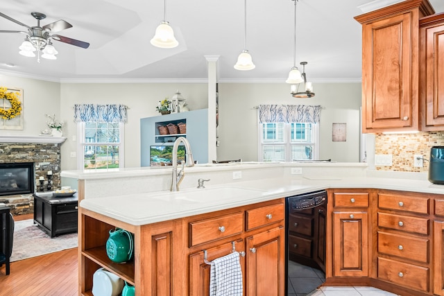 kitchen featuring a fireplace, sink, dishwasher, backsplash, and ornamental molding