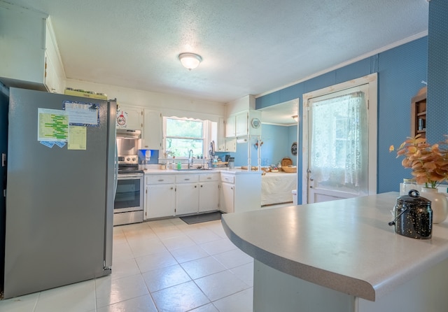 kitchen featuring white cabinets, stainless steel appliances, and light tile floors