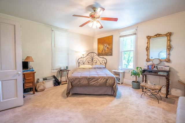 bedroom with carpet flooring, crown molding, and ceiling fan