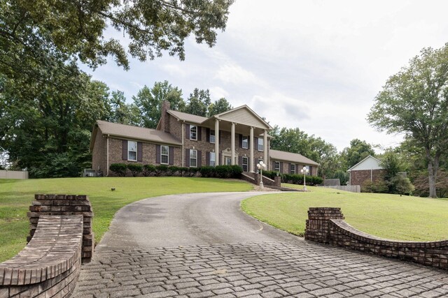 greek revival house featuring a front lawn