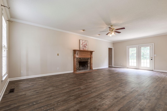 unfurnished living room with crown molding, dark hardwood / wood-style floors, and a brick fireplace