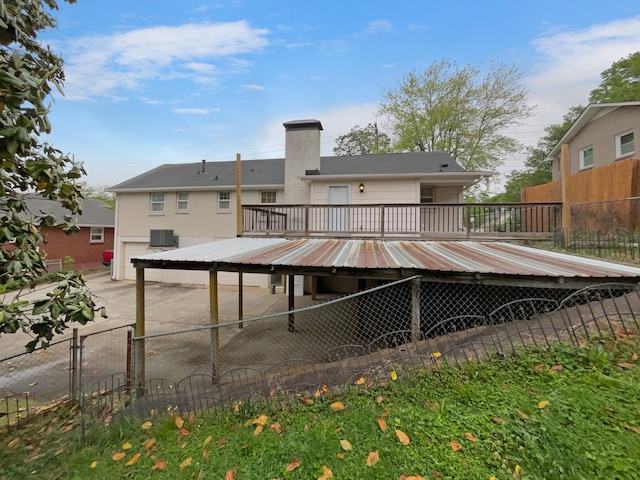 back of house with a deck