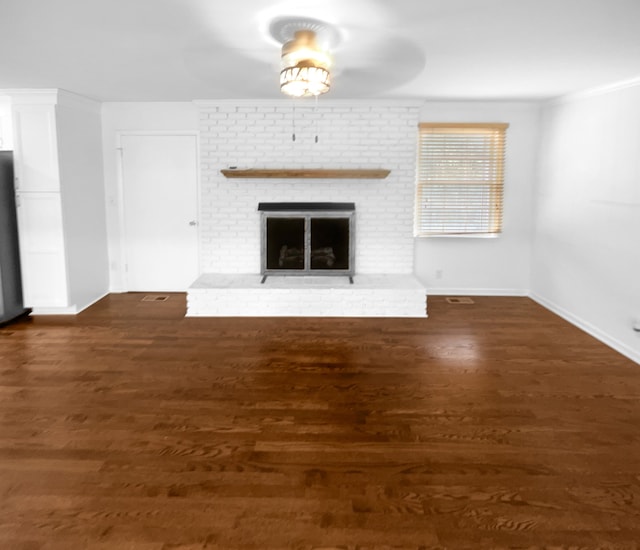 unfurnished living room featuring ceiling fan, a fireplace, and dark wood-type flooring